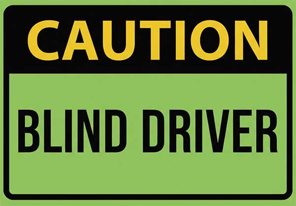 caution blind driver sign as seen on the back of Gary's green and black race suit