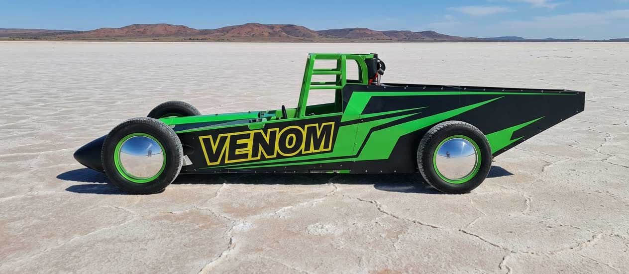 venom lakester in satin black with green race stripes pictured on the dry salt lake gairdner